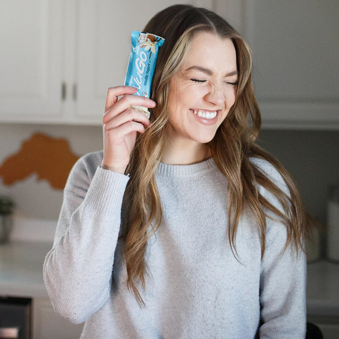 Laughing Woman holding NuGo Original Vanilla Yogurt
