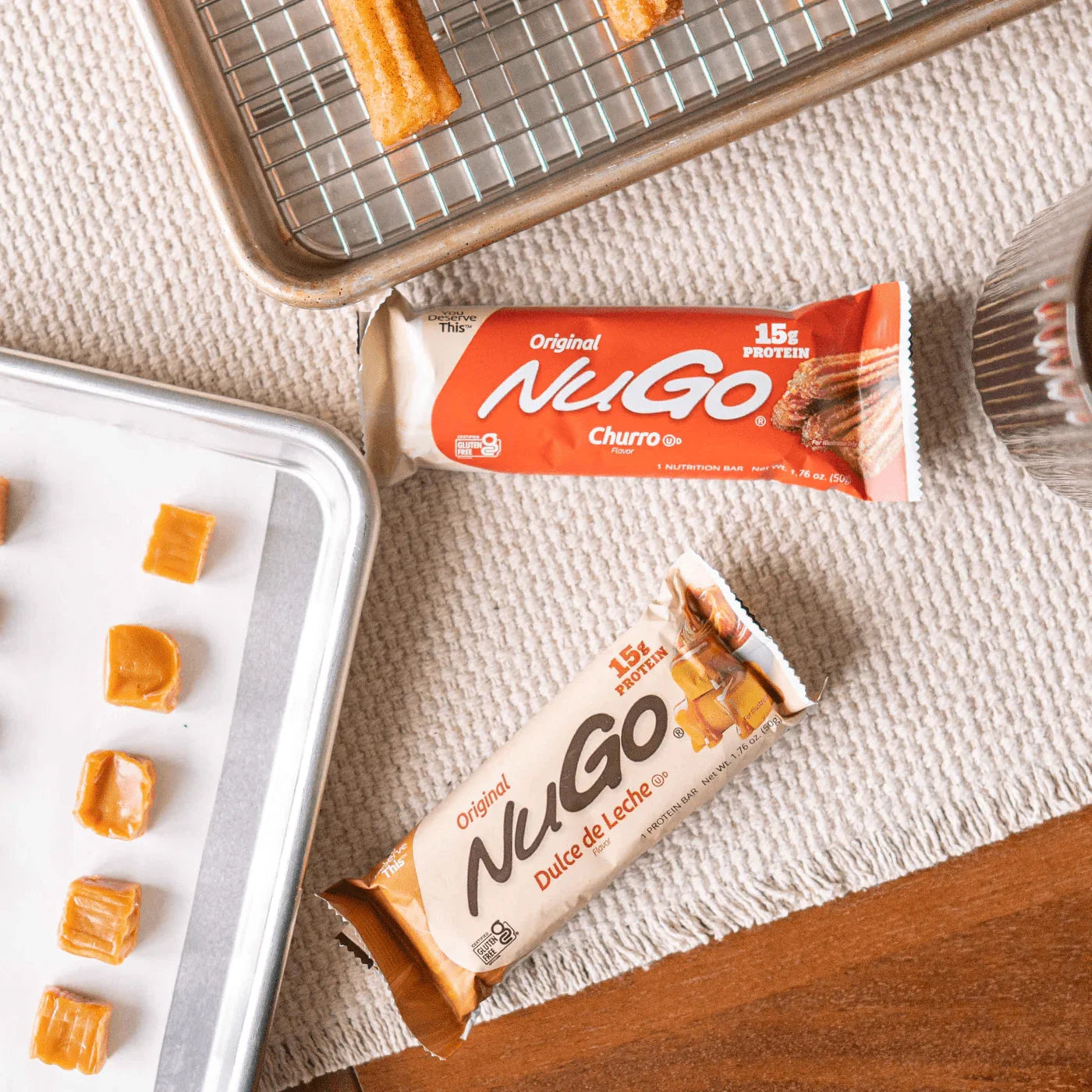 NuGo Churro and Dulce de Leche protein bars with baking trays and churros.