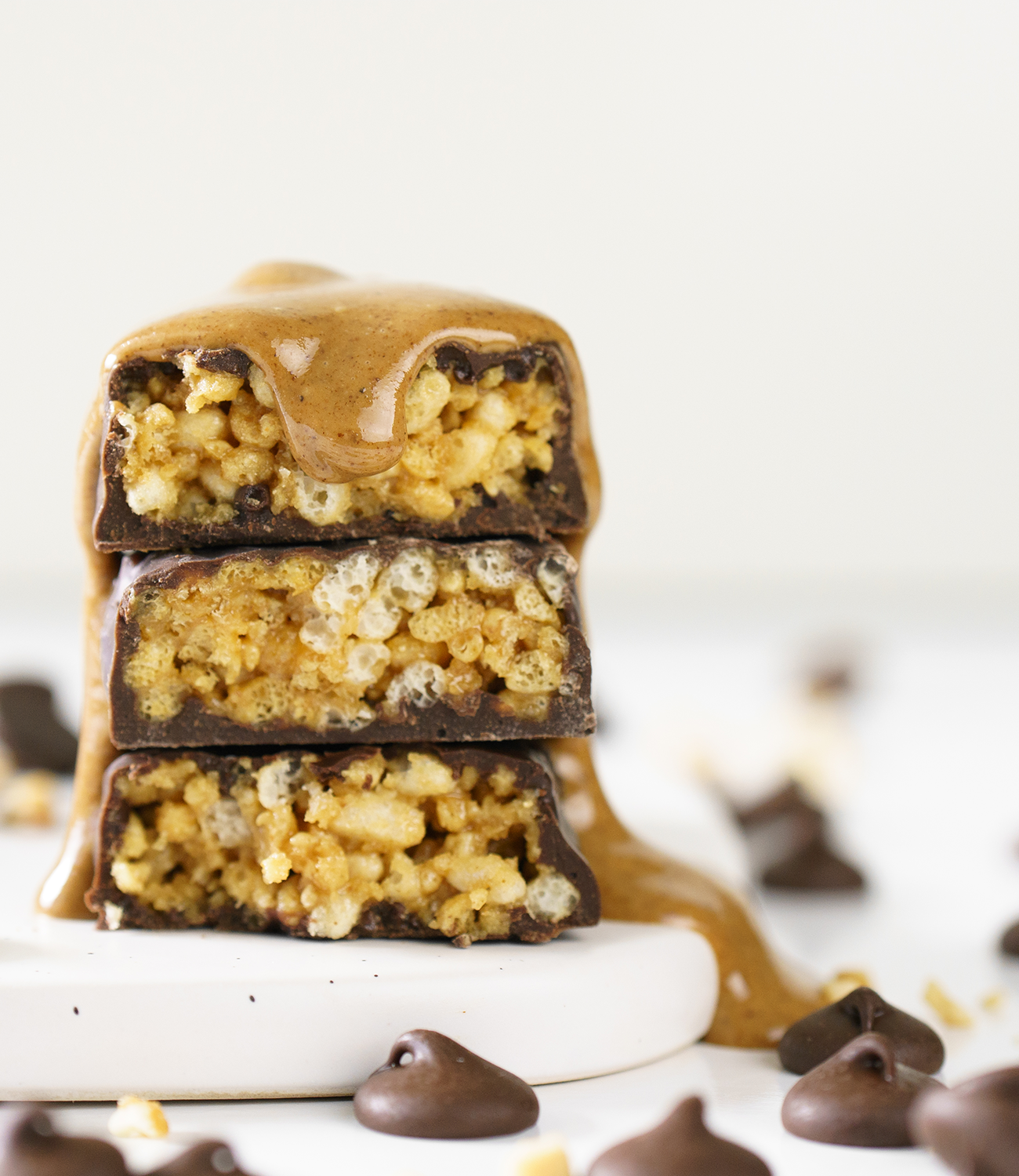 Peanut Butter drizzle over NuGo Dark Peanut Butter Cup cut into pieces and stacked