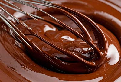 Whisk stirring melted chocolate