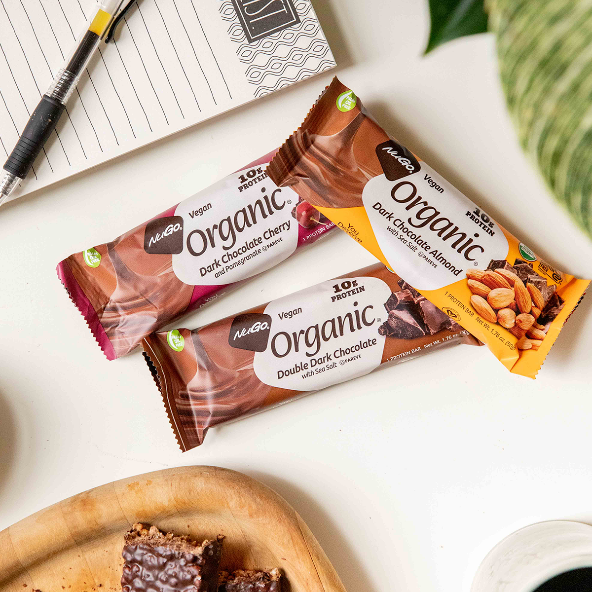 three Organic Bars next to tablet and plant