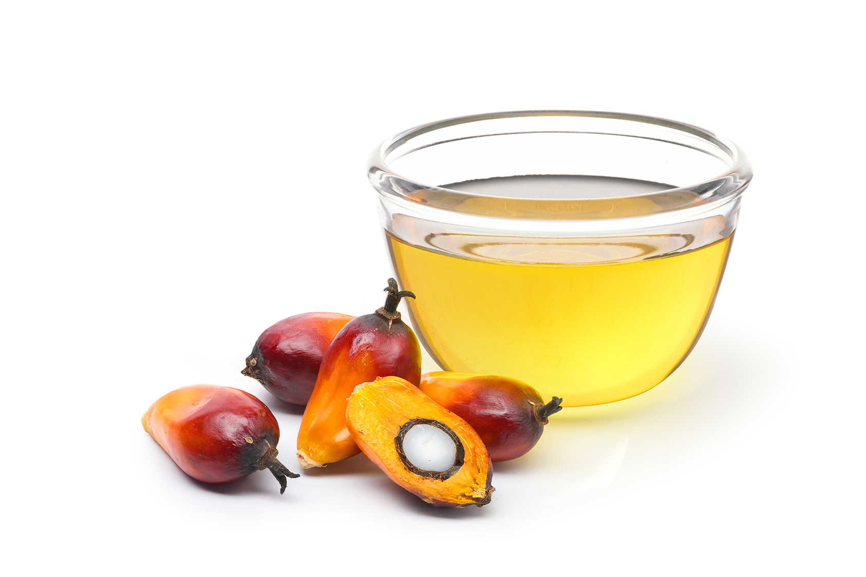 Palm fruit next to glass bowl with Palm Oil