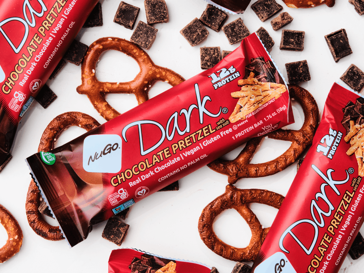 NuGo Dark Pretzel Bar on Pretzel and Chocolate background