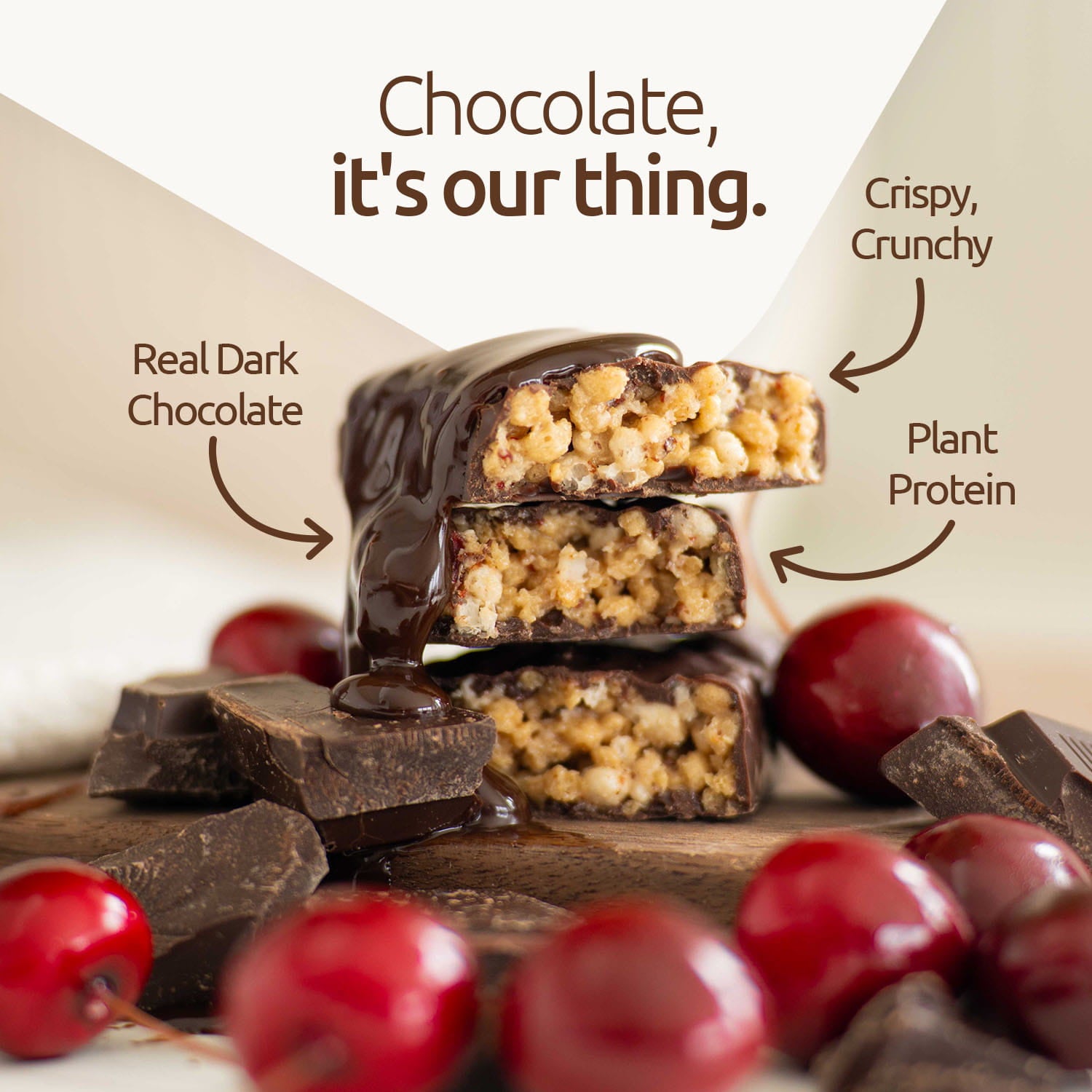 Dark chocolate bar with text highlighting ingredients on a wooden surface with red berries and chocolate.