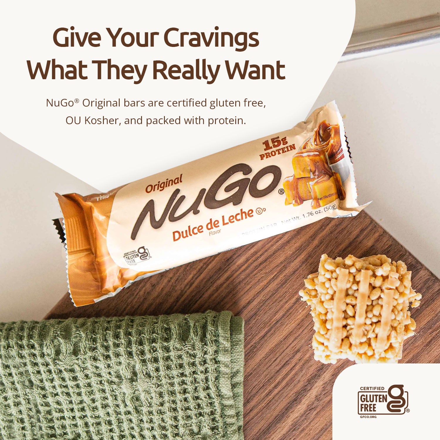 NuGo Dulce de Leche protein bar on a wooden surface with promotional text.