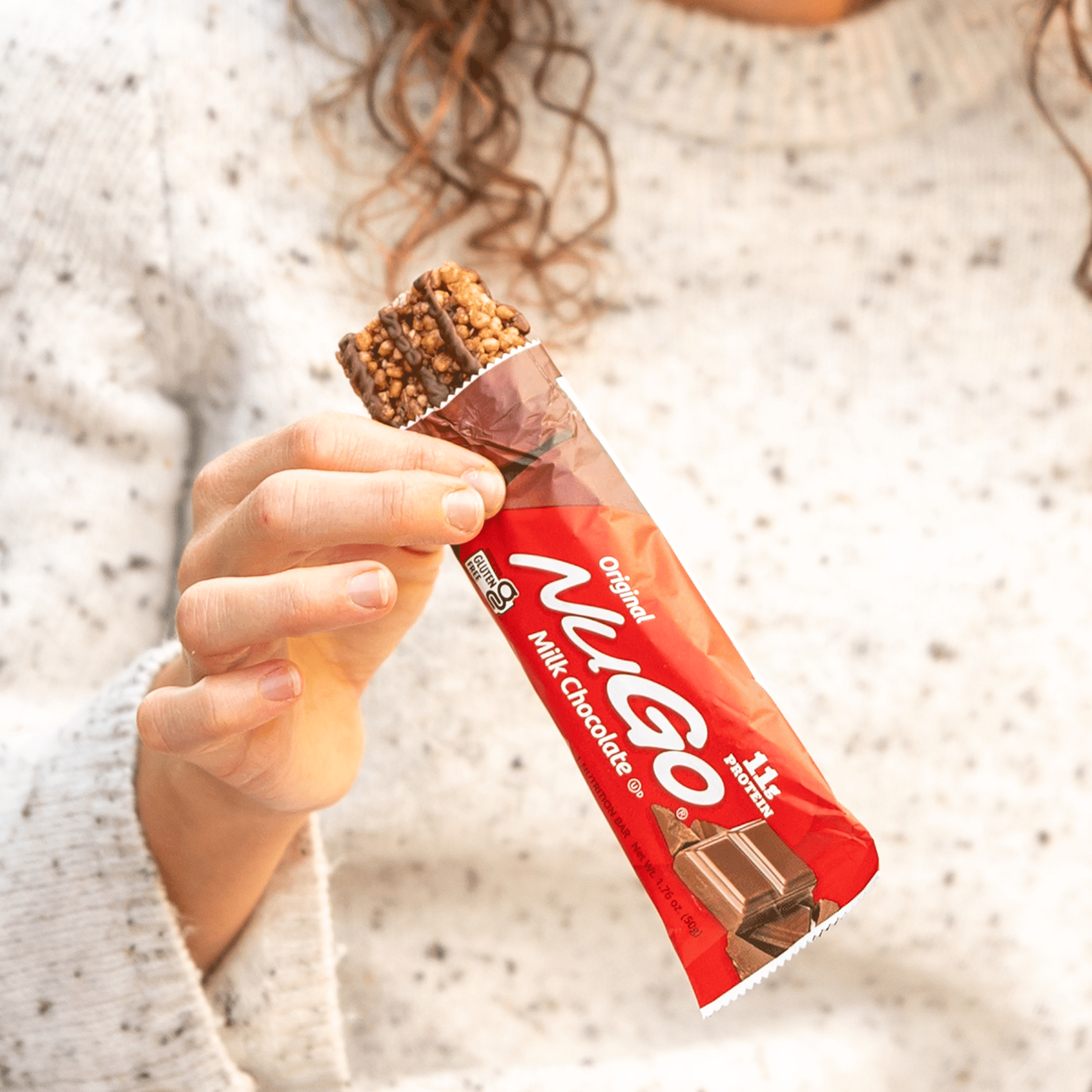 Woman holding open Milk Chocolate bar