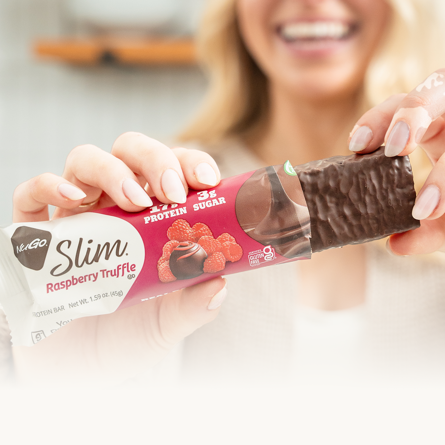 Girl holding nugo slim raspberry bar