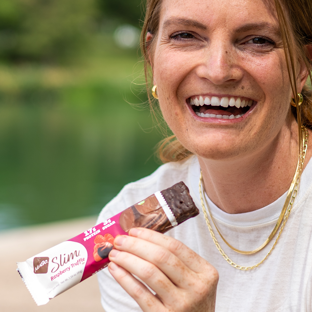 Happy Woman eating NuGo Slim Raspberry Truffle